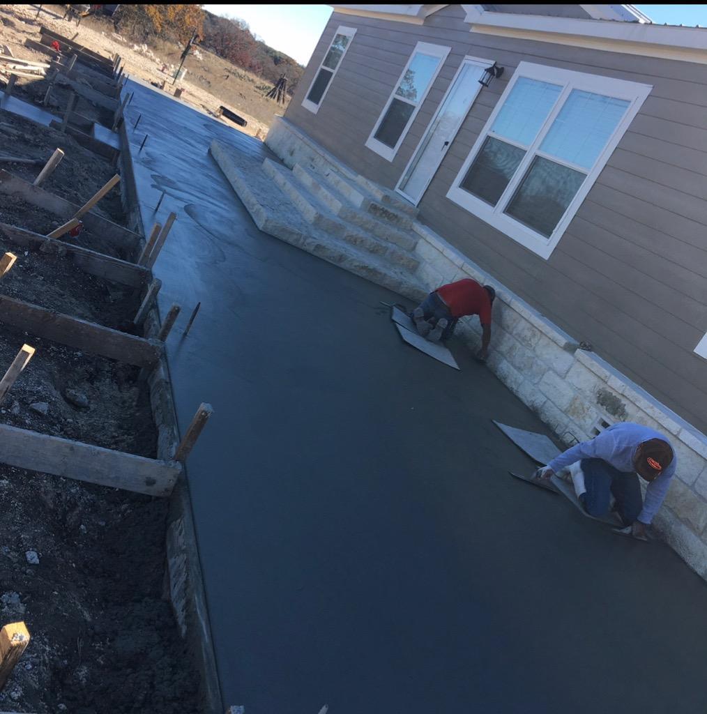 Men flattening concrete